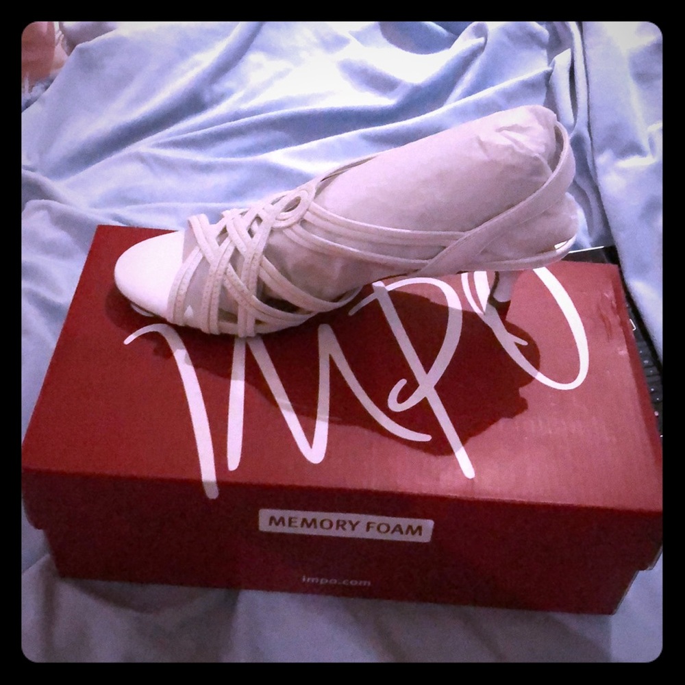 White dress shoes with small heel.